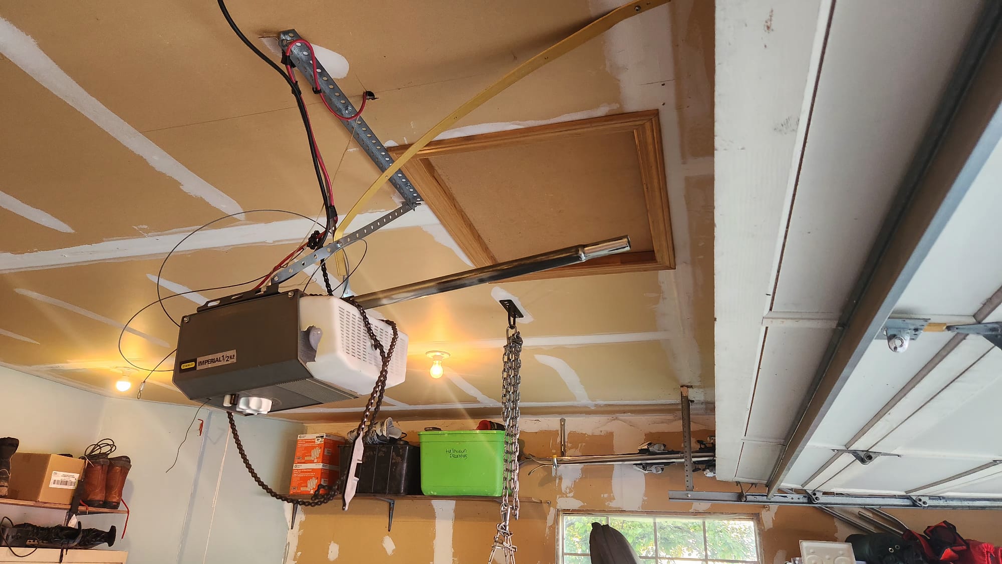 Older ceiling-mounted garage door opener with a damaged drive rail